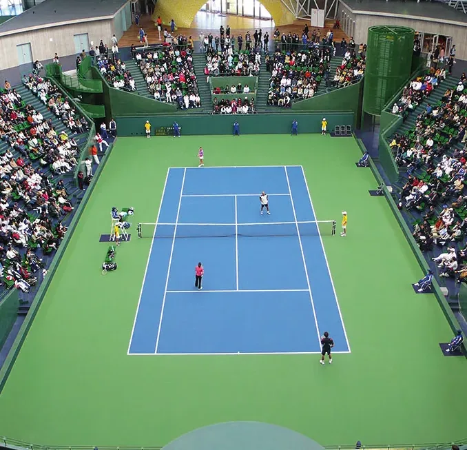 The centre court of the Bourbon Beans Dome seen from the stands, with the steel lattice roof above