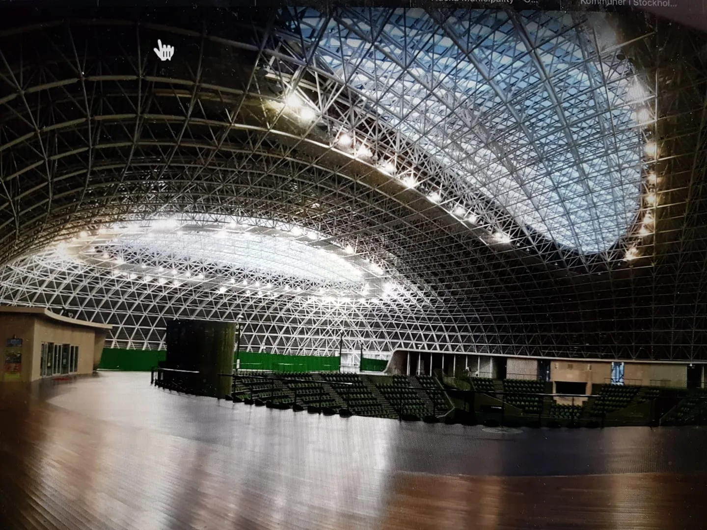 The floor of the Bourbon Beans Dome cleared for an event, with the stands and the steel lattice roof above
